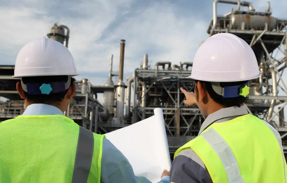 Engineers reviewing plans at an industrial site